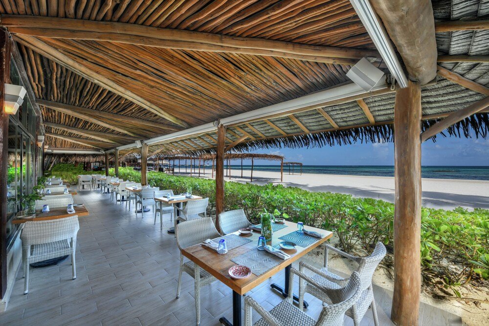 Outdoor pool and sun loungers at El Dorado Maroma