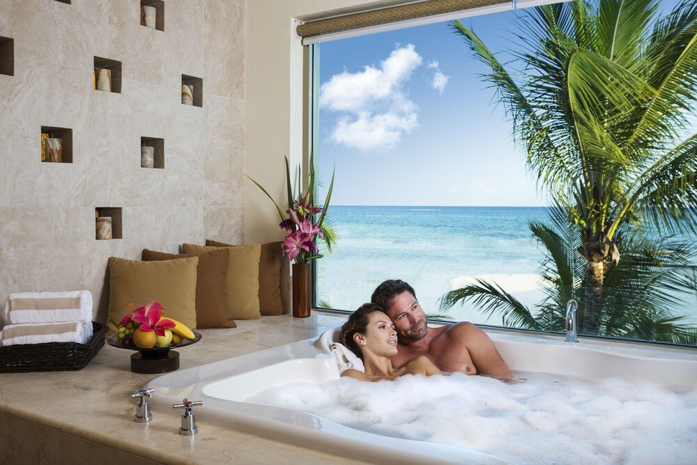 Private beach with loungers at El Dorado Maroma resort
