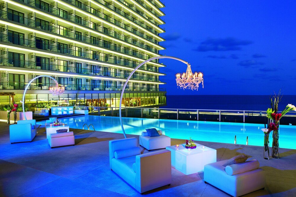 Pool area with cabanas at Secrets The Vine Cancun