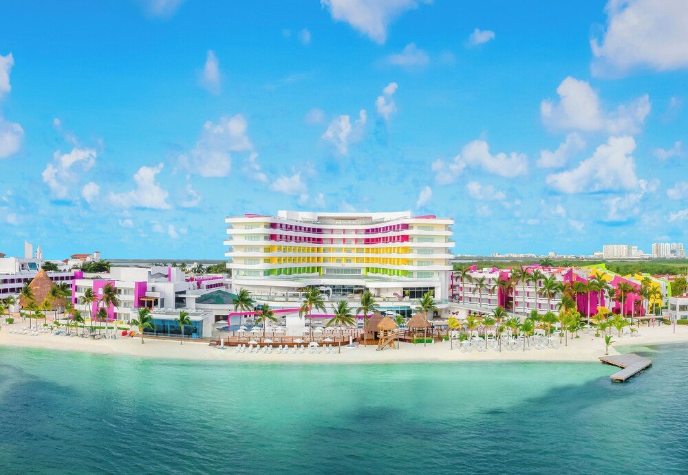 Outdoor pool with swim-up bar at Temptation at The Tower Cancún