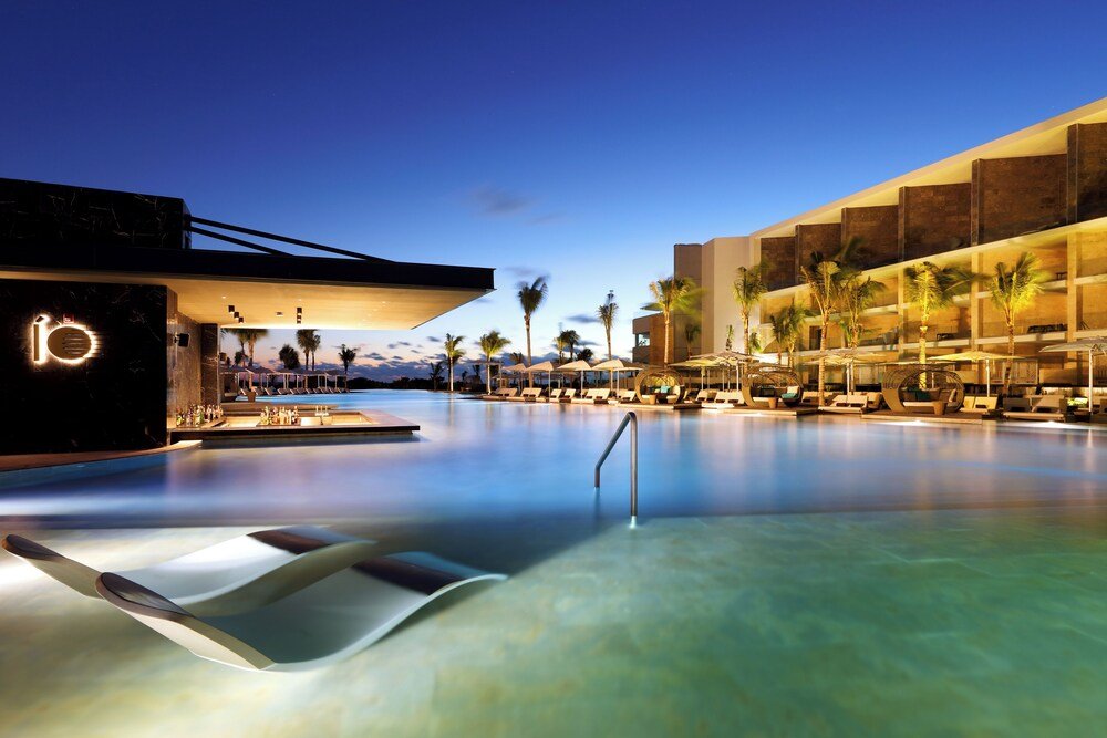 Outdoor pool and sun loungers at TRS Coral Hotel resort
